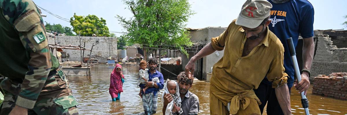People impacted by flooding in Pakistan flee their damaged homes