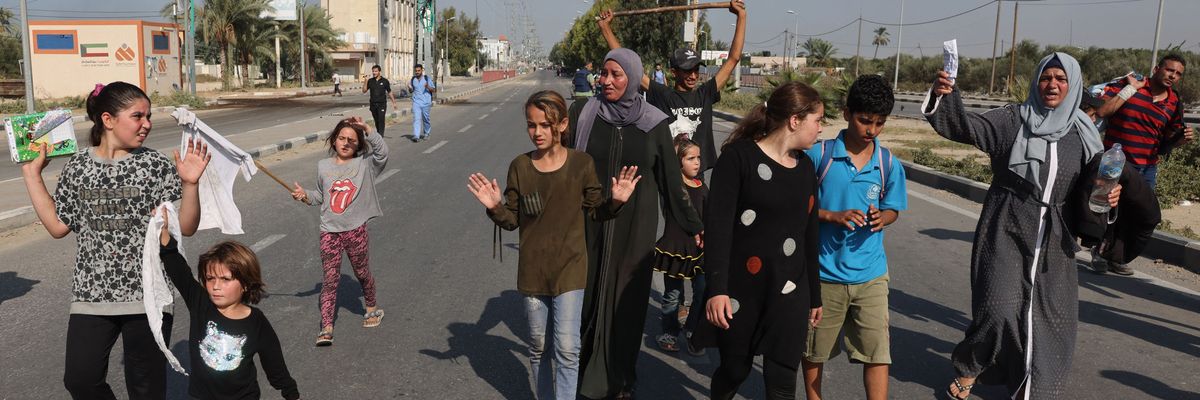 People in gaza wave white flags and raise their hands