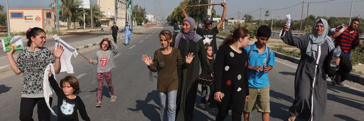 People in gaza wave white flags and raise their hands