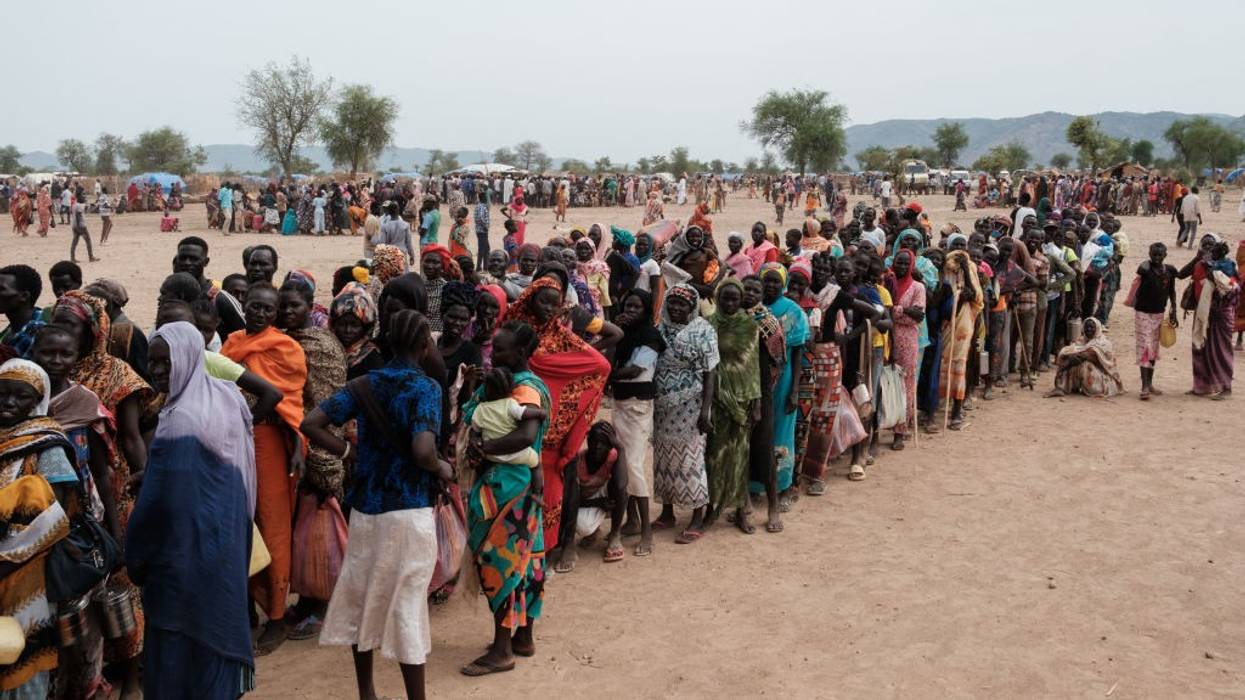 People in Sudan line up to register for food aid