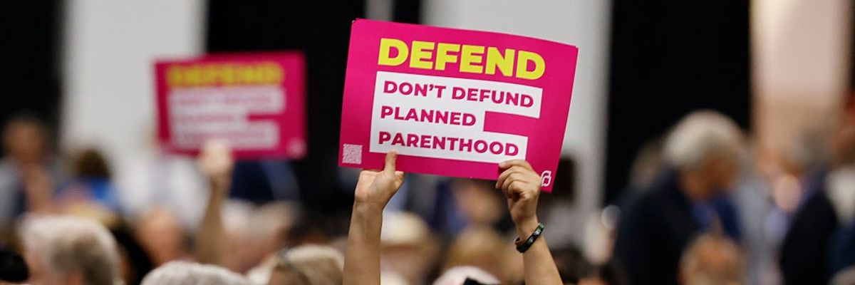People in the crowd hold pro-Planned Parenthood s