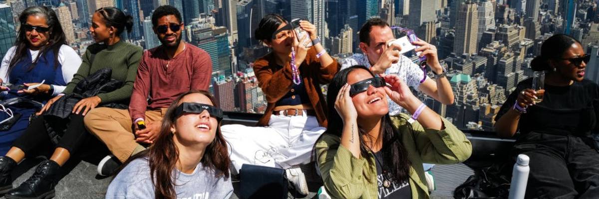 People in watch the solar eclipse in glasses.