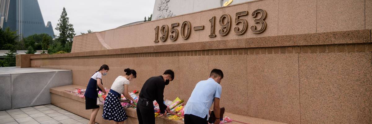People lay flowers at a North Korean war memorial.