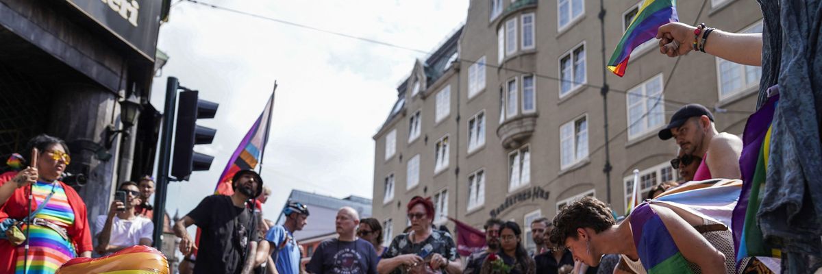People lay Pride flags