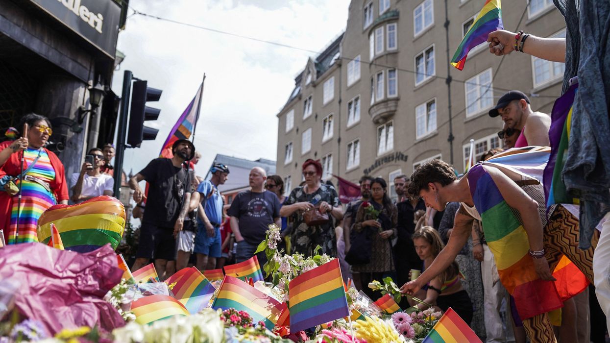 People lay Pride flags