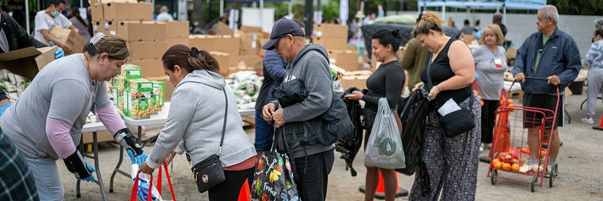 people line up at a food distribution center