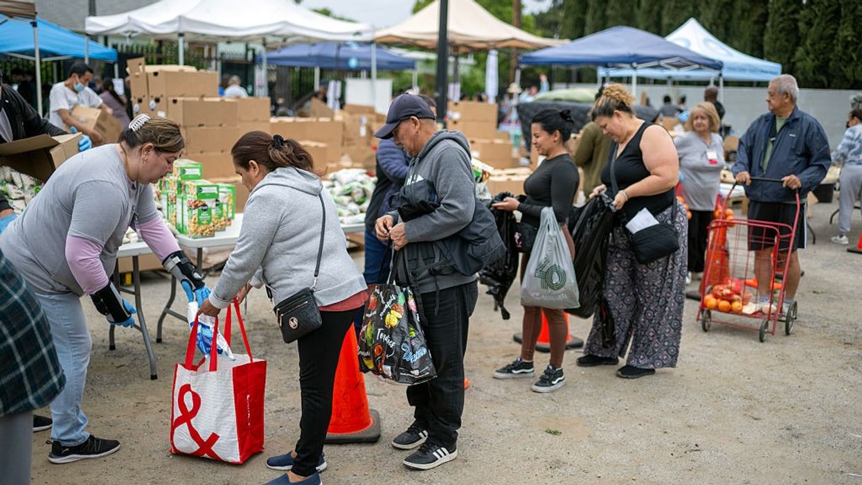 people line up at a food distribution center