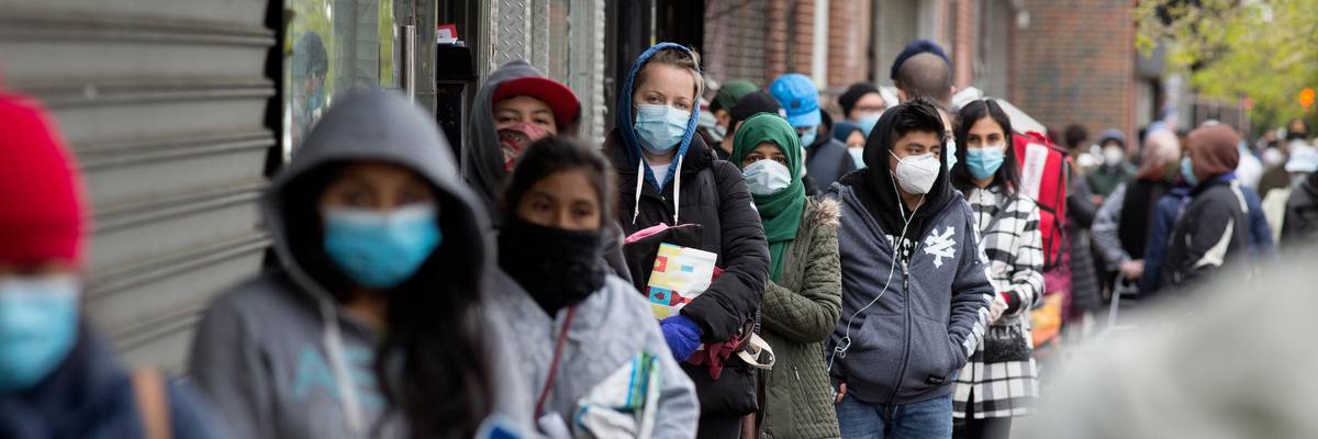 People line up to receive food from a food pantry