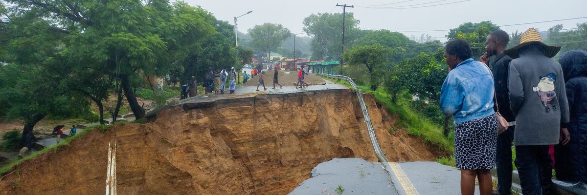 People look at a damaged road in Blantyre, Malawi on March 14, 2023.