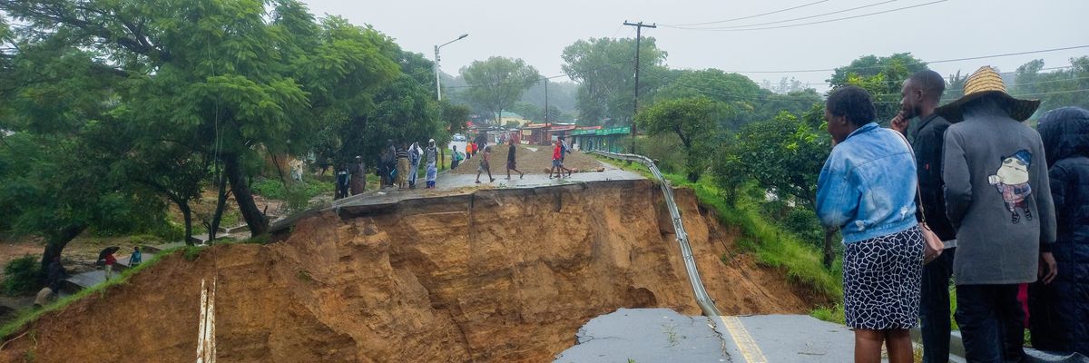People look at a damaged road in Blantyre, Malawi on March 14, 2023.