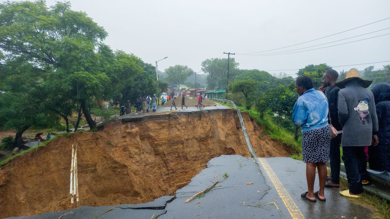 People look at a damaged road in Blantyre, Malawi on March 14, 2023.