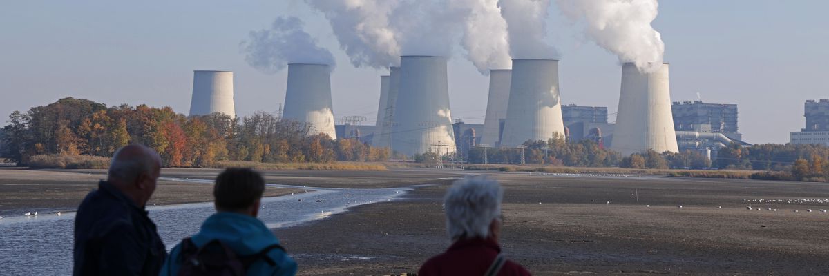 People look at the Jaenschwalde lignite coal-fired power plant.