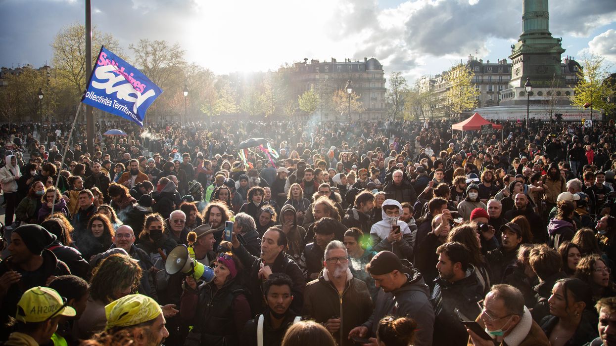 People march in Paris on April 13, 2023 to protest French President Emmanuel Macron's attack on the country's pension system.