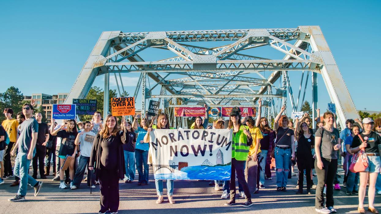 People march on bridge against data centers.