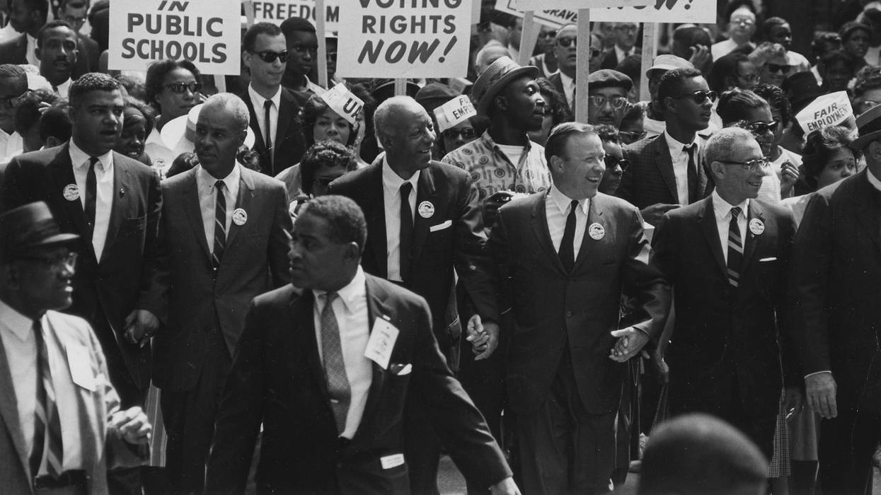 People march with signs in the 1963 March on Washington.