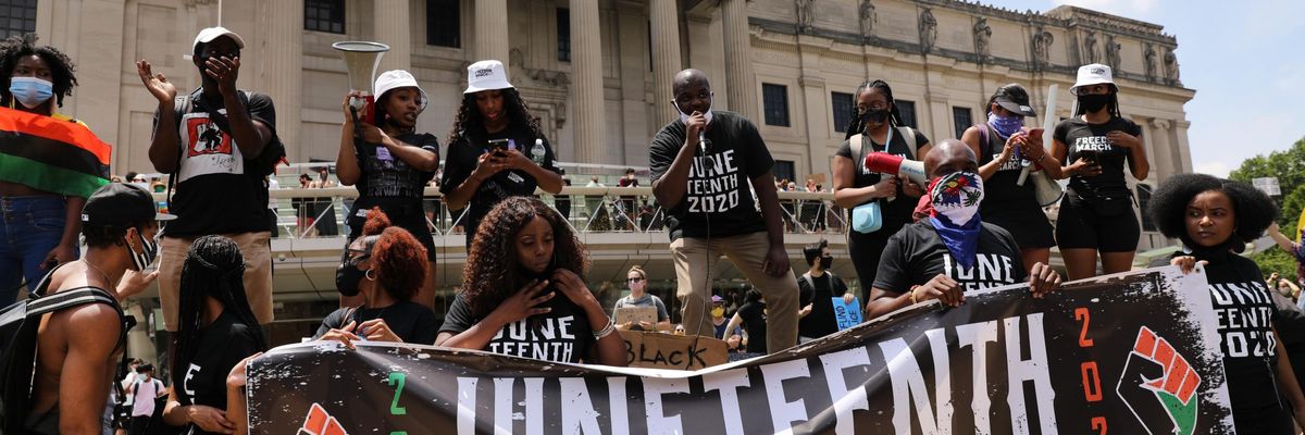People participate in a march in Brooklyn for both Black Lives Matter and to commemorate the 155th anniversary of Juneteenth on June 19, 2020 in New York City
