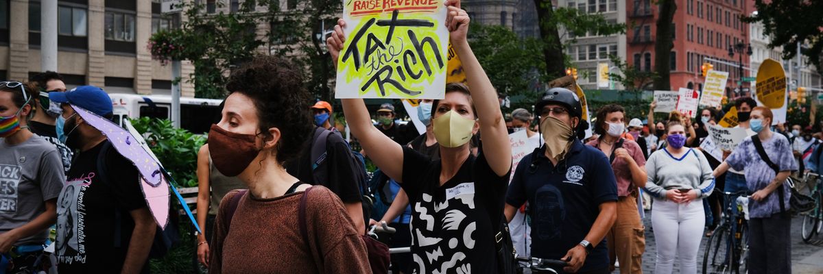 People participate in a "march on billionaires" event
