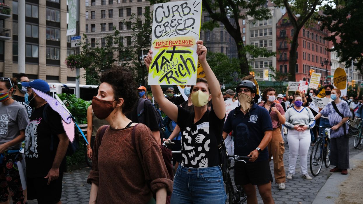 People participate in a "march on billionaires" event