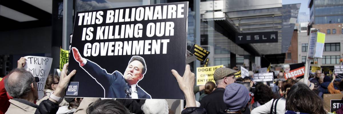 People participate in a protest against Elon Musk