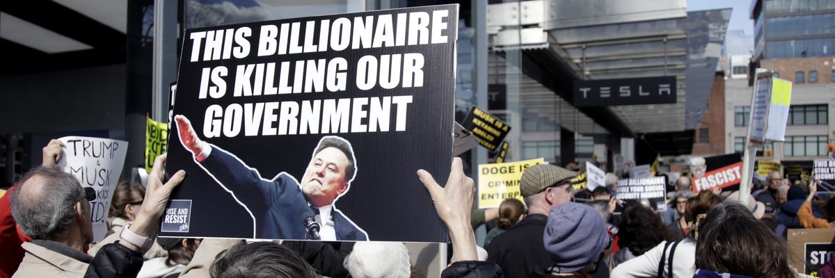 People participate in a protest against Elon Musk