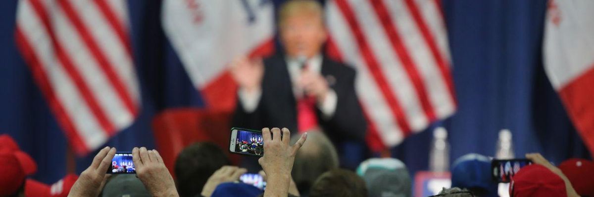 People photographing Donald Trump with their smartphones at a campaign rally in Council Bluffs, Iowa