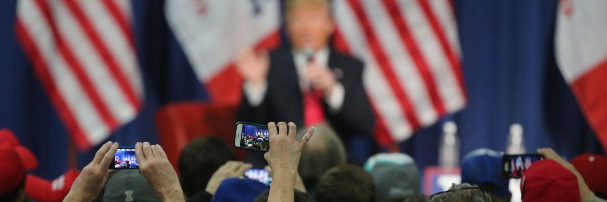 People photographing Donald Trump with their smartphones at a campaign rally in Council Bluffs, Iowa