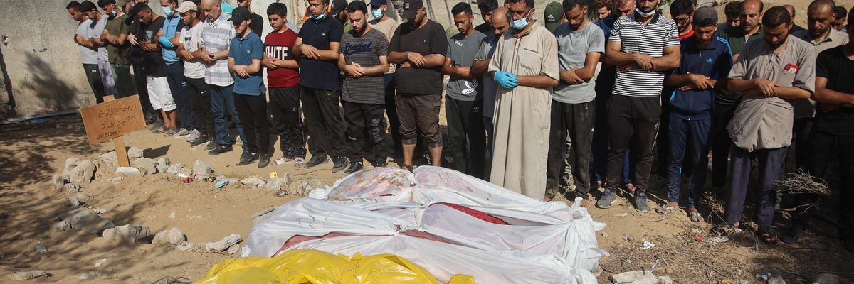 People pray by bodies