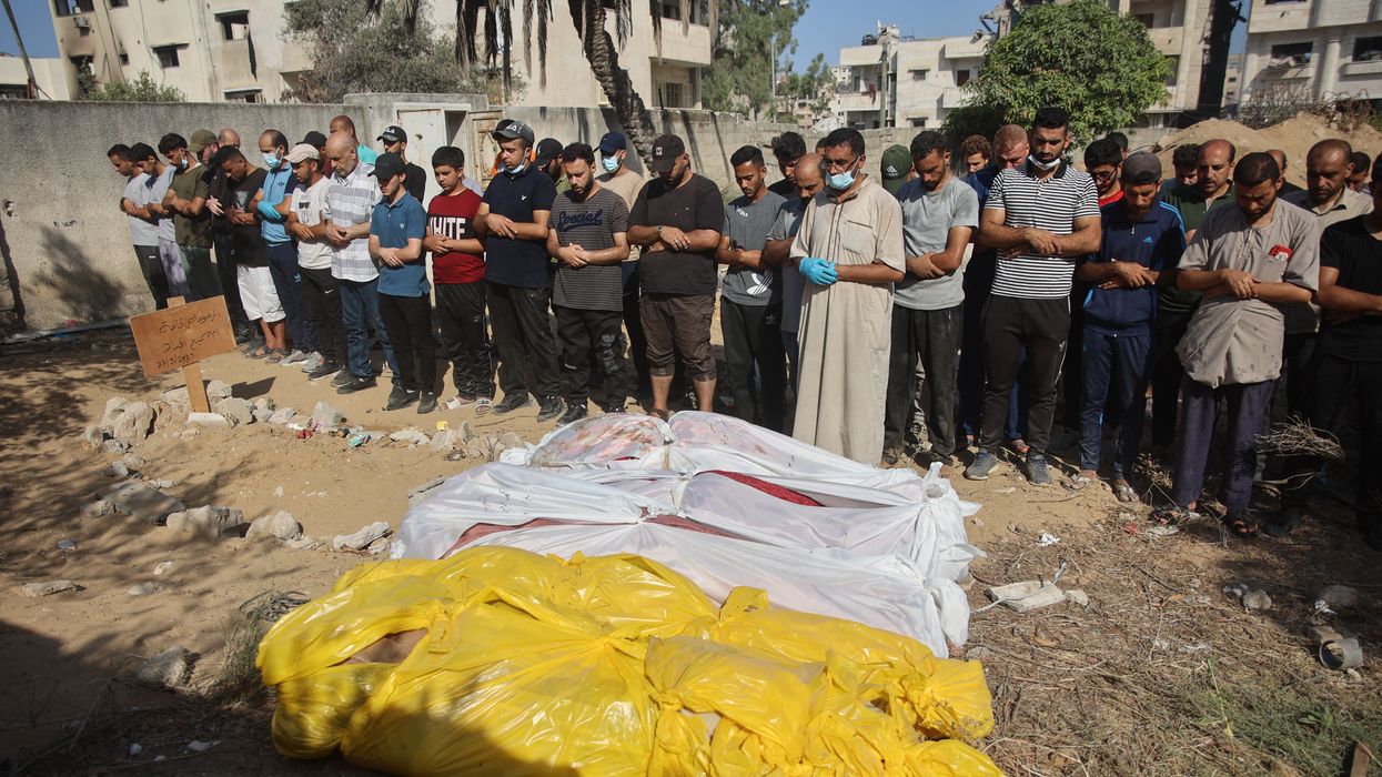 People pray by bodies