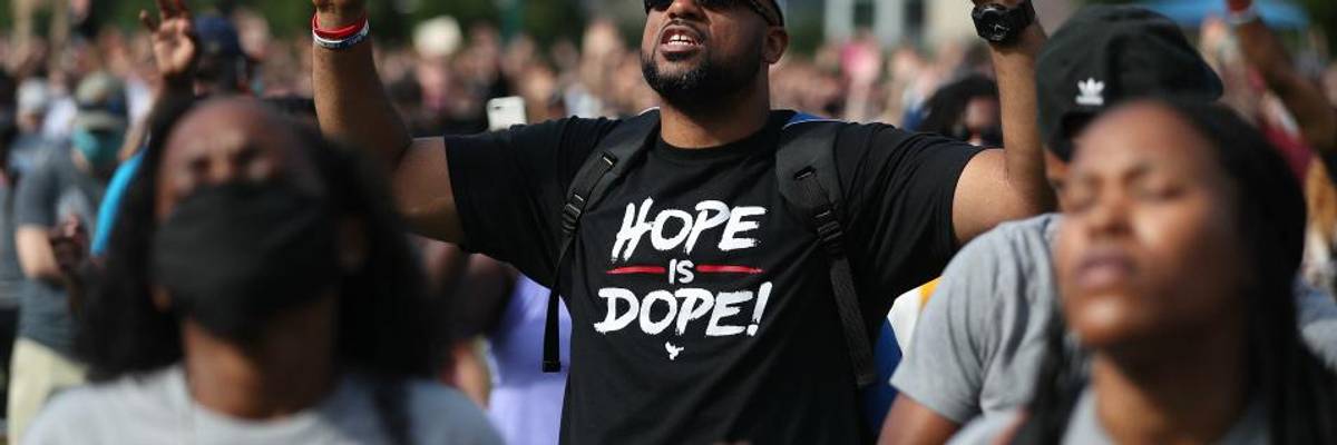 People pray together during a Juneteenth event