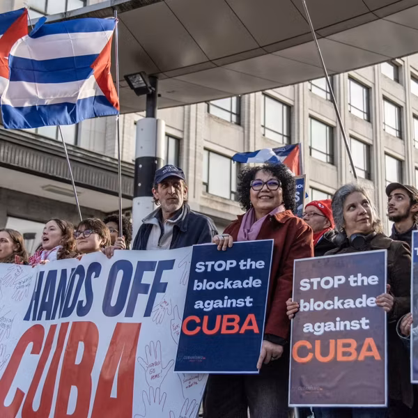 People protest against Trump aggression against Cuba with signs reading "Stop the Blockade Against Cuba"