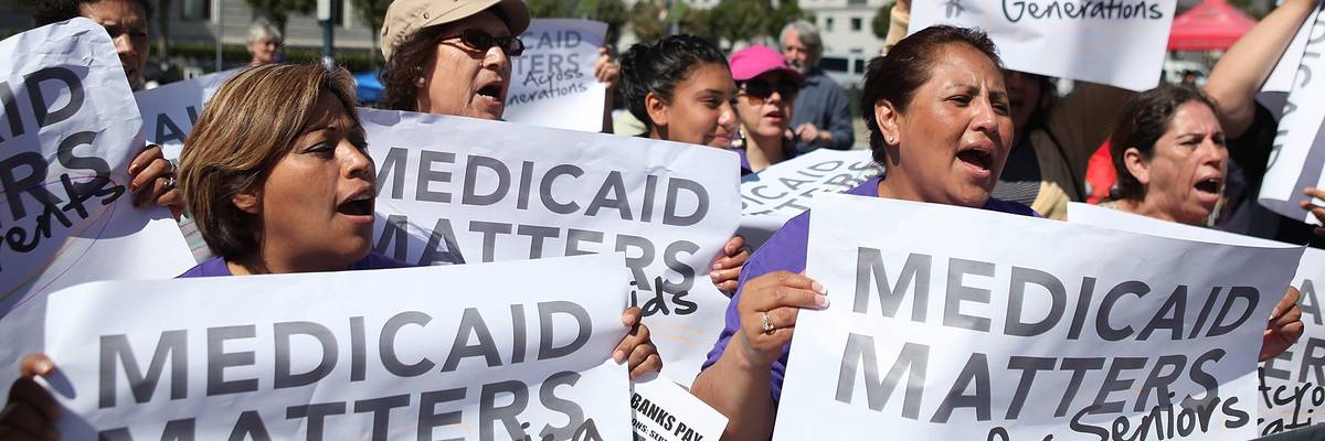 People protest cuts to Medicaid.