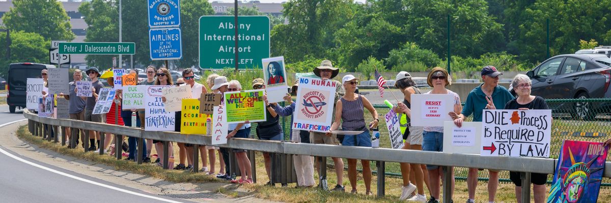People protest deportation flights.