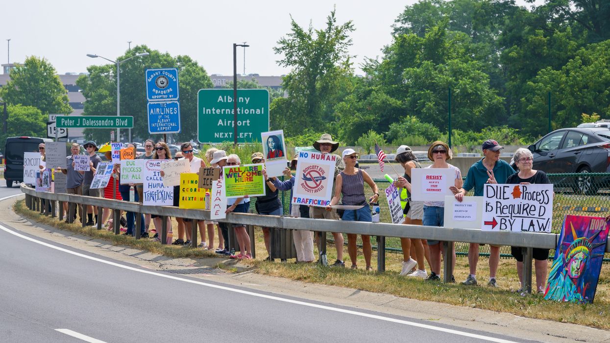 People protest deportation flights.