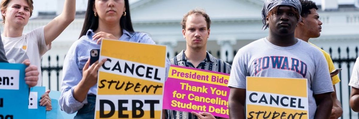 People protest for student debt cancellation outside the White House
