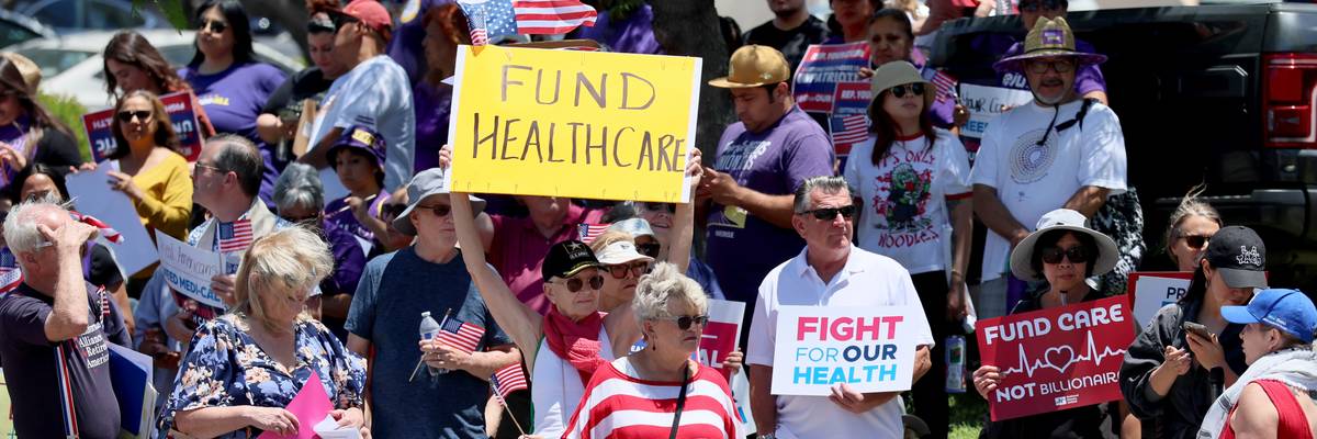 People protest GOP health cuts.