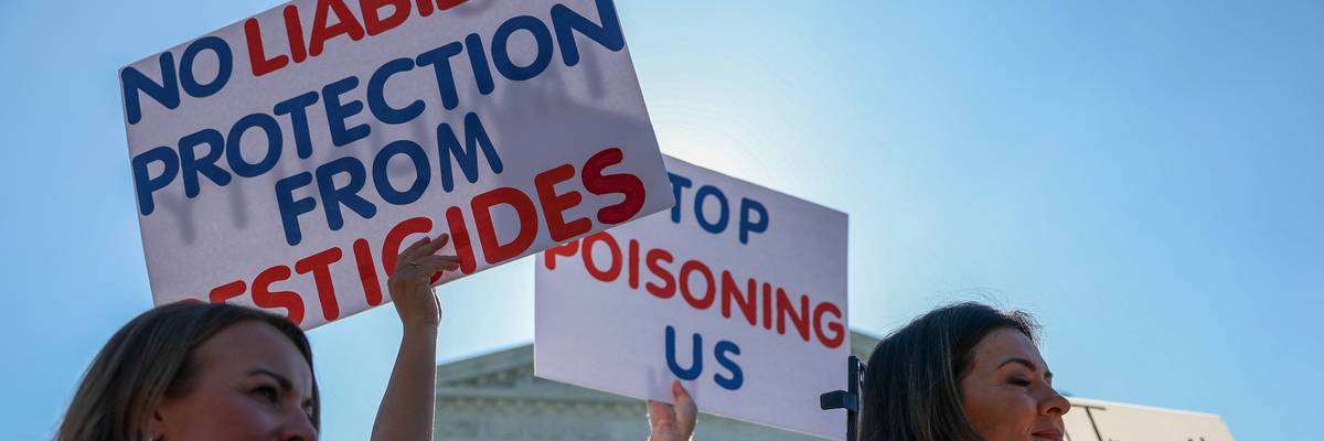People protest liability protection for pesticide companies.