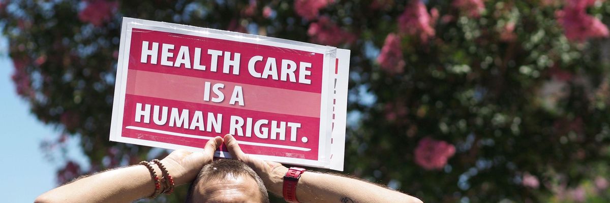 People rally in favor of single-payer healthcare. "Healthcare is a human right."
