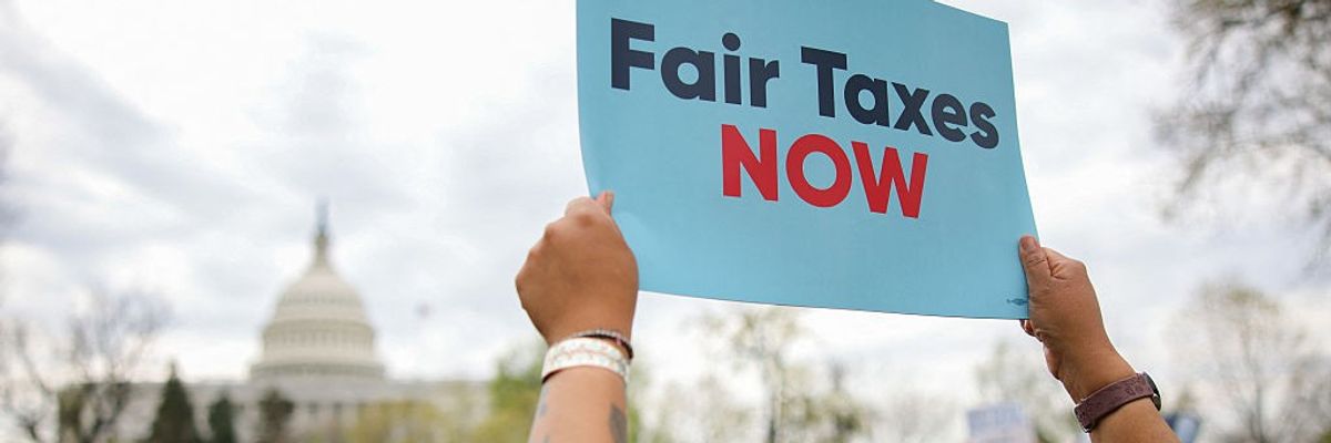 People rally in support of fair taxation near the U.S. Capitol