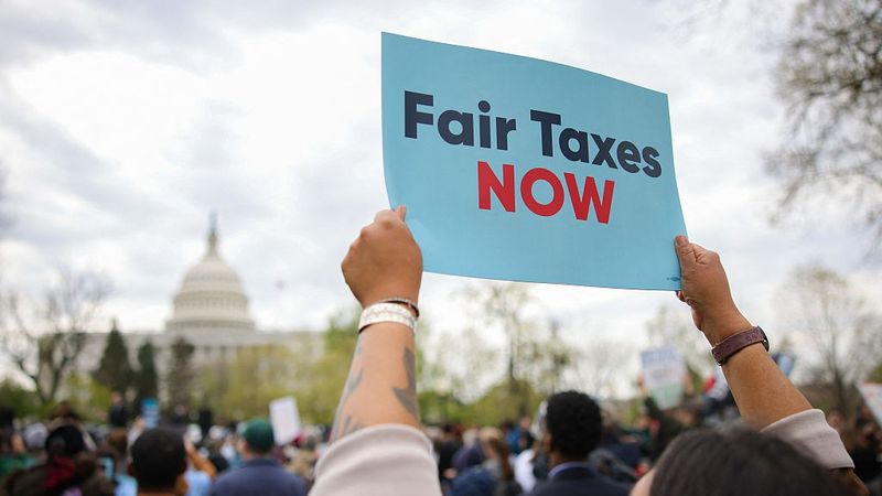 People rally in support of fair taxation near the U.S. Capitol
