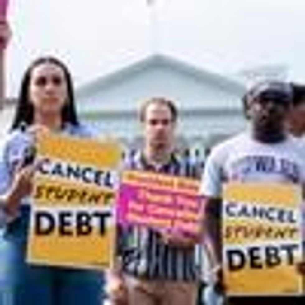 People rally in support of student debt cancellation outside of the White House