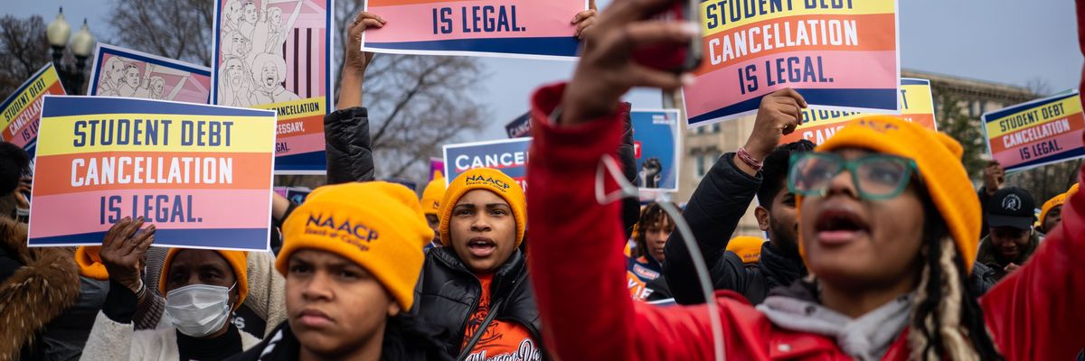 People rally in support of the Biden administration's student debt relief plan in front of the Supreme Court