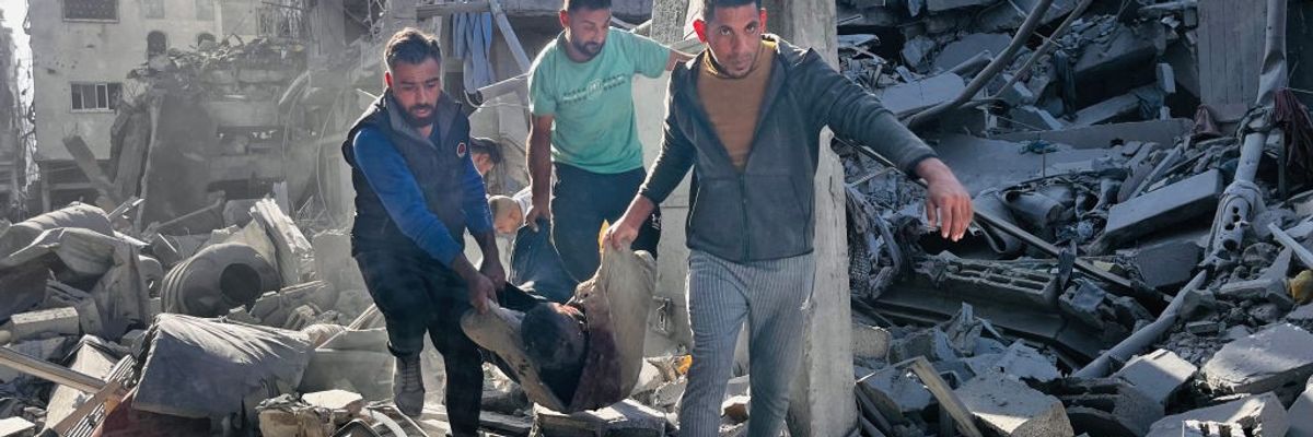 People remove body from rubble of building in Gaza