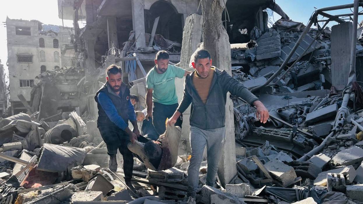 People remove body from rubble of building in Gaza