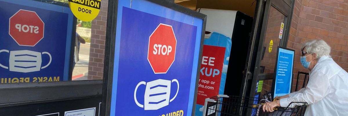 People shop at a store enforcing mask-wearing requirements