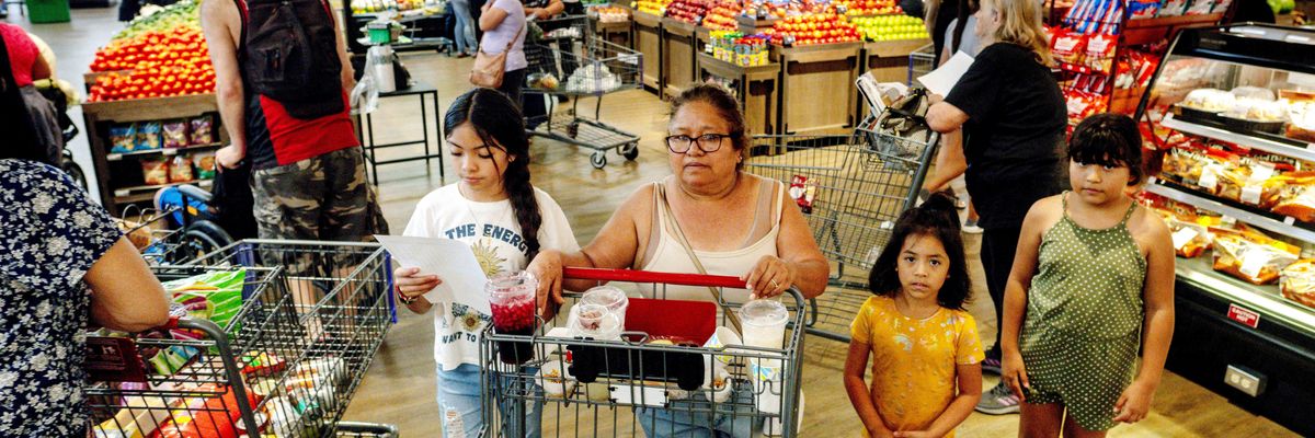 People shop for groceries in Riverside, California on September 28, 2022.