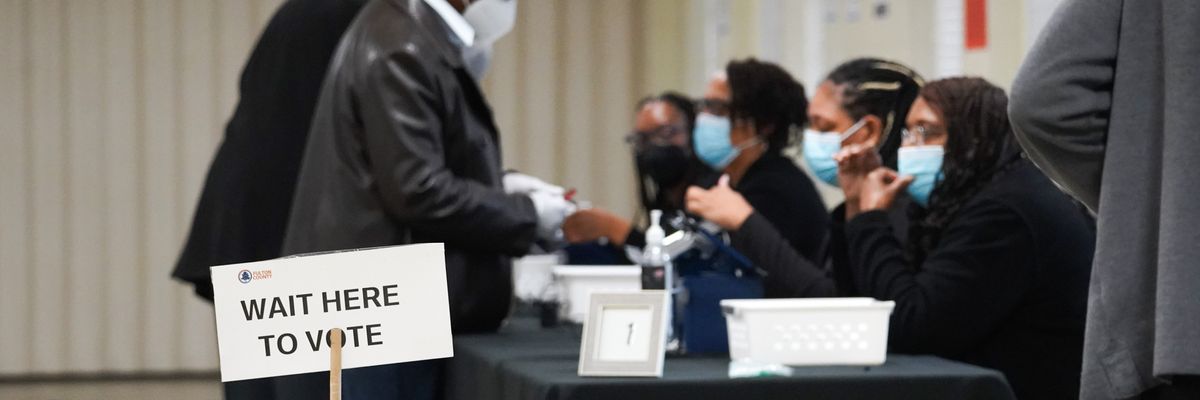 People sign in to cast their votes on the first day of early voting in Georgia