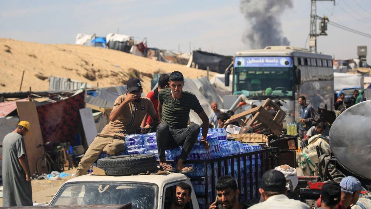 People sitting on and above vehicles as they sit in traffic in Gaza