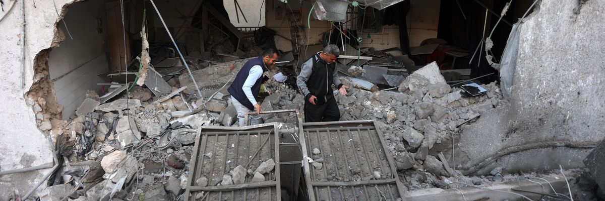 People sort through rubble of hospital in Gaza.