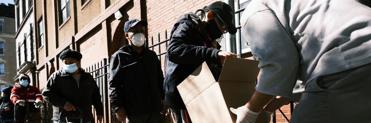People stand in line during the pandemic for food aid.