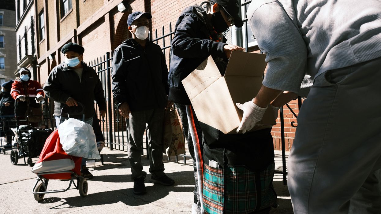 People stand in line during the pandemic for food aid.